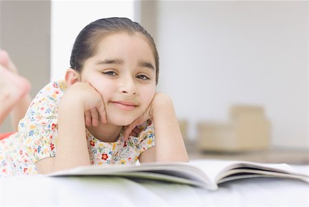 preteen asian girls bed - Girl lying on the bed with a book Stock Photo - Premium Royalty-Free, Code: 630-02219298