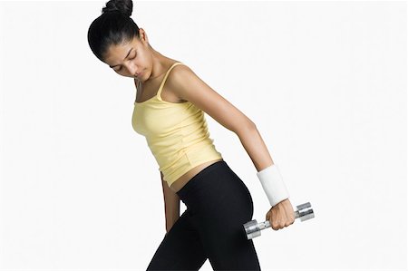 simsearch:630-02219883,k - Young woman exercising with a dumbbell Foto de stock - Sin royalties Premium, Código: 630-02219305