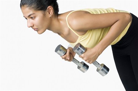 simsearch:630-02219691,k - Young woman exercising with dumbbells Foto de stock - Sin royalties Premium, Código: 630-02219307