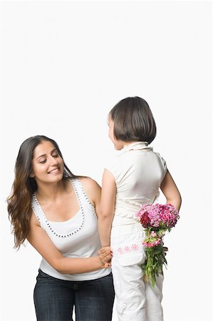 simsearch:630-02221095,k - Rear view of a girl hiding a bunch of flowers behind her back from her mother Foto de stock - Sin royalties Premium, Código: 630-02219335