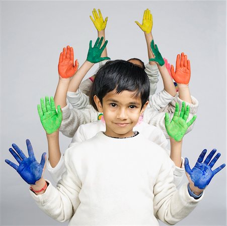 Group of children standing in a row and showing their painted palms Stock Photo - Premium Royalty-Free, Code: 630-02219375