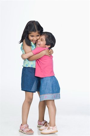 simsearch:630-02220906,k - Two girls hugging each other and smiling Stock Photo - Premium Royalty-Free, Code: 630-02219440