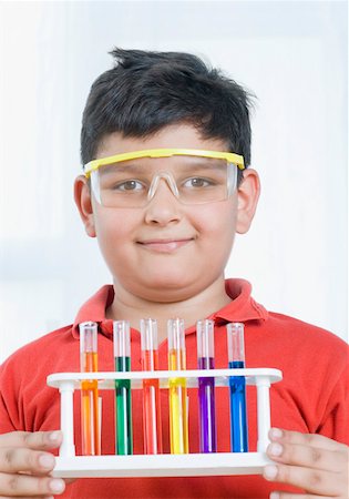 Close-up of a boy holding a test tube holder Stock Photo - Premium Royalty-Free, Code: 630-02219465