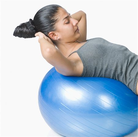 simsearch:630-02220846,k - Young woman exercising with a fitness ball Stock Photo - Premium Royalty-Free, Code: 630-02219497