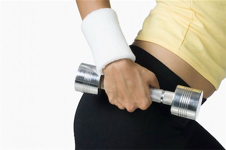simsearch:630-02220846,k - Mid section view of a young woman holding a dumbbell Stock Photo - Premium Royalty-Free, Code: 630-02219500