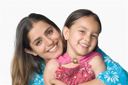 simsearch:630-02221095,k - Portrait of a young woman hugging her daughter from behind and smiling Foto de stock - Sin royalties Premium, Código: 630-02219538