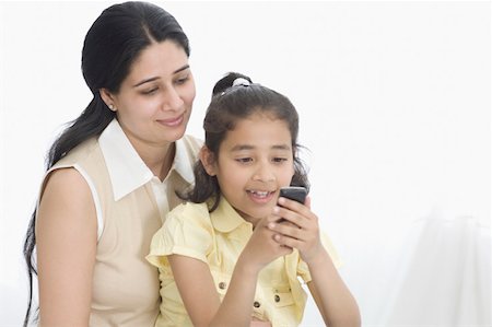 simsearch:630-02219353,k - Close-up of a girl text messaging on a mobile phone with her mother Stock Photo - Premium Royalty-Free, Code: 630-02219546