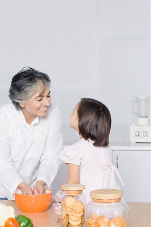 simsearch:630-02219554,k - Girl looking at her grandmother preparing food Stock Photo - Premium Royalty-Free, Code: 630-02219559