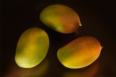 food on black - Close-up of three mangoes Stock Photo - Premium Royalty-Free, Code: 630-02219683