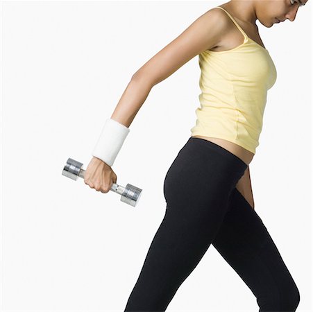 simsearch:630-02220846,k - Side profile of a young woman exercising with a dumbbell Stock Photo - Premium Royalty-Free, Code: 630-02219691