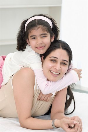 Portrait of a girl lying on the back of her mother Stock Photo - Premium Royalty-Free, Code: 630-02219741