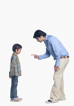 pictures of angry father and son - Side profile of a young man shouting on his son Stock Photo - Premium Royalty-Free, Code: 630-02219755