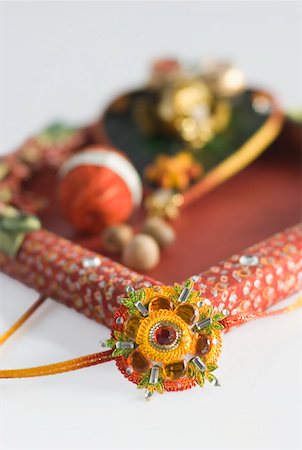 rakhi - Close-up of a rakhi with a rakhi thali Stock Photo - Premium Royalty-Free, Code: 630-02219834