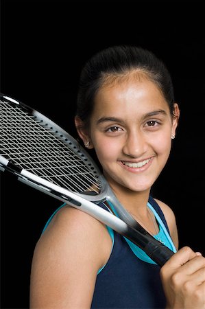 Portrait of a teenage girl holding a badminton racket Stock Photo - Premium Royalty-Free, Code: 630-02219857