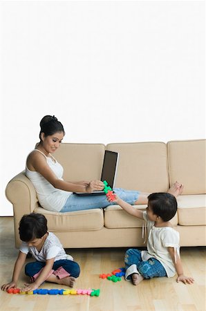 simsearch:630-02220024,k - Girl giving toys to her mother and her sister playing with toys near them Stock Photo - Premium Royalty-Free, Code: 630-02219865