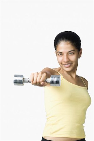 simsearch:630-02219883,k - Portrait of a young woman exercising with a dumbbell Foto de stock - Sin royalties Premium, Código: 630-02219882