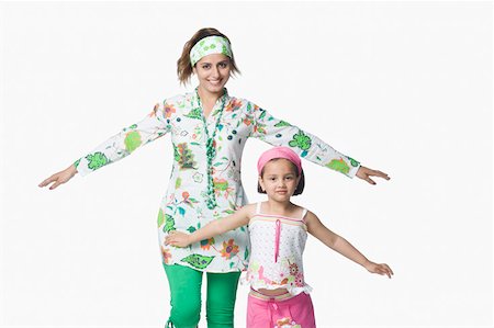 simsearch:630-02221095,k - Portrait of a young woman and her daughter standing with their arms outstretched Foto de stock - Sin royalties Premium, Código: 630-02219927