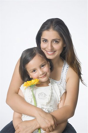 simsearch:630-02219353,k - Portrait of a young woman hugging her daughter from behind and smiling Stock Photo - Premium Royalty-Free, Code: 630-02219921