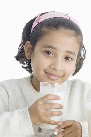 Portrait of a girl holding a glass of milk Stock Photo - Premium Royalty-Free, Code: 630-02219963
