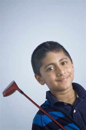 simsearch:630-02220721,k - Portrait of a boy holding a golf club and smiling Foto de stock - Sin royalties Premium, Código: 630-02219990