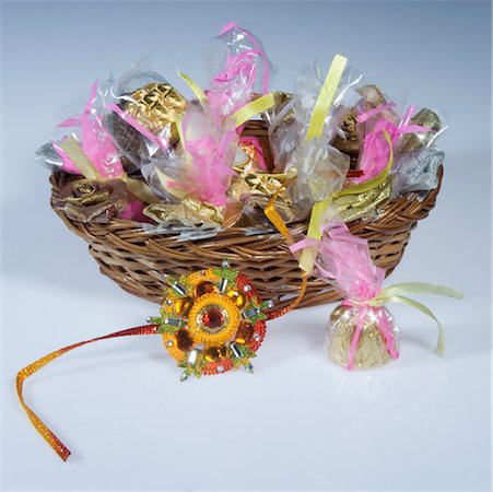 polythene - Close-up of a rakhi with sweets in a wicker basket Stock Photo - Premium Royalty-Free, Code: 630-02220034