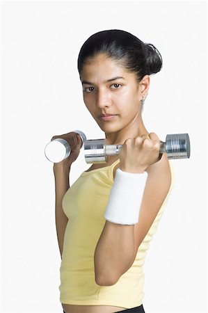 simsearch:630-02220846,k - Young woman exercising with dumbbells Stock Photo - Premium Royalty-Free, Code: 630-02220074