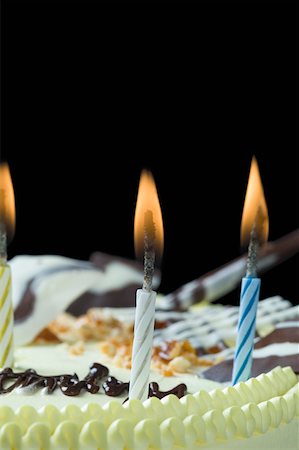 Close-up of lit candles on a birthday cake Stock Photo - Premium Royalty-Free, Code: 630-02220089
