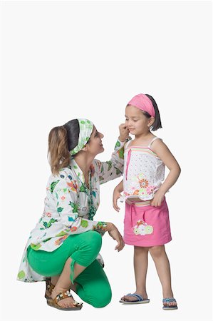 Side profile of a young woman pinching her daughter's cheek Foto de stock - Royalty Free Premium, Número: 630-02220108