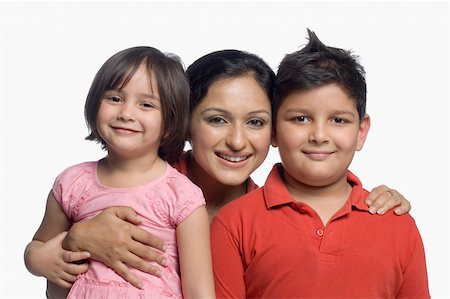 simsearch:630-02219463,k - Portrait of a mid adult woman smiling with her son and daughter Foto de stock - Sin royalties Premium, Código: 630-02220139