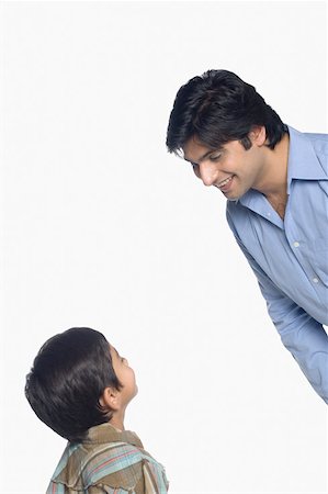 simsearch:630-02219554,k - Young man and his son looking at each other Stock Photo - Premium Royalty-Free, Code: 630-02220146