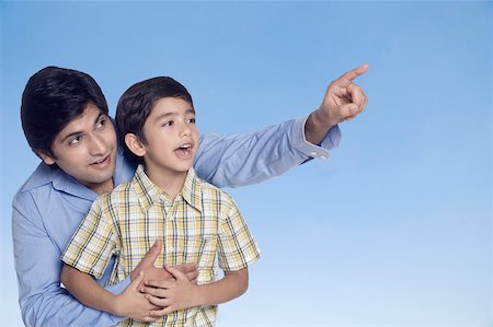 Close-up of a young man pointing and his son looking away Stock Photo - Premium Royalty-Free, Code: 630-02220140