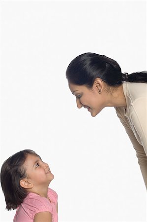simsearch:630-02219591,k - Mid adult woman and her daughter looking at each other Stock Photo - Premium Royalty-Free, Code: 630-02220143
