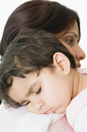 simsearch:630-02219591,k - Close-up of a girl sleeping on her mother's shoulder Stock Photo - Premium Royalty-Free, Code: 630-02220181