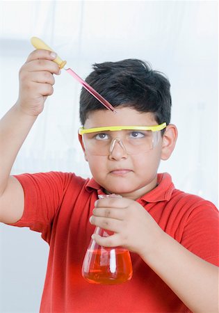 Close-up of a boy holding a conical flask and a pipette Stock Photo - Premium Royalty-Free, Code: 630-02220257