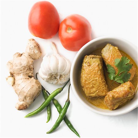 Close-up of fish curry served in a bowl with raw vegetables Stock Photo - Premium Royalty-Free, Code: 630-02220367