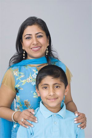simsearch:630-02219554,k - Portrait of a boy with his mother standing behind him and smiling Stock Photo - Premium Royalty-Free, Code: 630-02220385