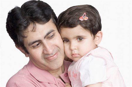 simsearch:630-02219591,k - Close-up of a mid adult man cheek to cheek with his daughter Stock Photo - Premium Royalty-Free, Code: 630-02220380