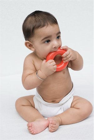 Close-up of a baby boy playing with a toy Stock Photo - Premium Royalty-Free, Code: 630-02220403