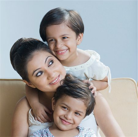 Young woman smiling with her two daughters smiling Stock Photo - Premium Royalty-Free, Code: 630-02220456
