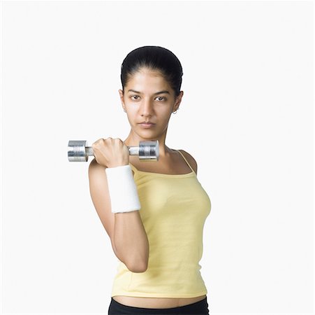 simsearch:630-02219883,k - Young woman exercising with a dumbbell Foto de stock - Sin royalties Premium, Código: 630-02220476