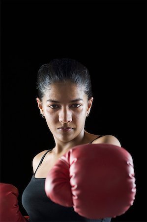 Portrait of a female boxer in boxing stance Stock Photo - Premium Royalty-Free, Code: 630-02220479