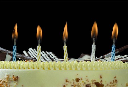 Close-up of lit candles on a birthday cake Stock Photo - Premium Royalty-Free, Code: 630-02220486