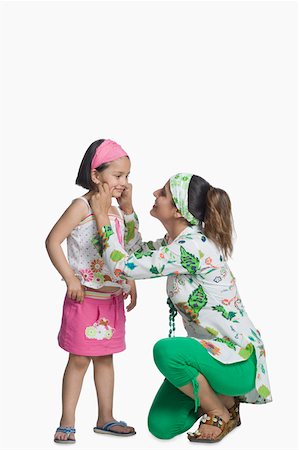 slippers girls - Side profile of a young woman pinching her daughter's cheek Stock Photo - Premium Royalty-Free, Code: 630-02220511