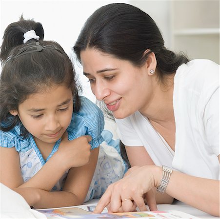 simsearch:630-02219353,k - Close-up of a mid adult woman teaching her daughter Stock Photo - Premium Royalty-Free, Code: 630-02220536