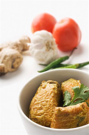 Close-up of fish curry served in a bowl with raw vegetables Stock Photo - Premium Royalty-Free, Code: 630-02220574