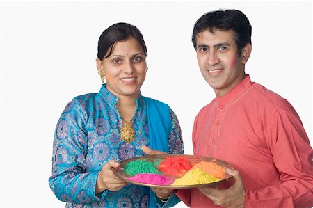Portrait of a mid adult couple holding a plate of powder paint and smiling Stock Photo - Premium Royalty-Free, Code: 630-02220582