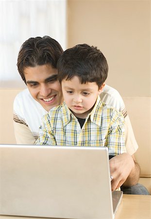 simsearch:630-02219554,k - Close-up of a young man using a laptop with his son and smiling Foto de stock - Sin royalties Premium, Código: 630-02220605