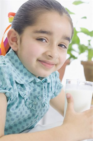 Portrait of a girl holding a glass of milk Stock Photo - Premium Royalty-Free, Code: 630-02220649