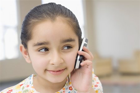 Close-up of a girl talking on a mobile phone Stock Photo - Premium Royalty-Free, Code: 630-02220655