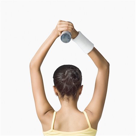 simsearch:630-02220846,k - Rear view of a young woman exercising with a dumbbell Stock Photo - Premium Royalty-Free, Code: 630-02220658